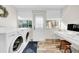 Bright laundry room, featuring washer, dryer, desk, and backyard access at 216 21St Ne Ave, St Petersburg, FL 33704