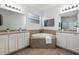 Double vanity bathroom with a large garden tub and neutral tile at 2291 Bolzano Ct, Land O Lakes, FL 34639