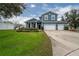 Two-story house with blue siding, white trim, and a landscaped front yard at 2291 Bolzano Ct, Land O Lakes, FL 34639