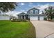 Two-story home with a two-car garage and landscaped lawn at 2291 Bolzano Ct, Land O Lakes, FL 34639