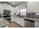 Modern kitchen with white cabinets, granite counters, and stainless steel appliances at 2291 Bolzano Ct, Land O Lakes, FL 34639