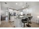 Modern kitchen with white cabinets, granite counters, and an island with seating at 2291 Bolzano Ct, Land O Lakes, FL 34639