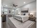 Large main bedroom with grey walls, a king-size bed, and dark hardwood floors at 2291 Bolzano Ct, Land O Lakes, FL 34639