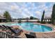 Community pool with lounge chairs and shaded areas at 2291 Bolzano Ct, Land O Lakes, FL 34639