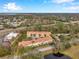 Aerial view showing townhouses near a golf course and highway at 2648 Tanglewood Trl, Palm Harbor, FL 34685