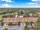 Aerial view of townhouses near a golf course and a pond at 2648 Tanglewood Trl, Palm Harbor, FL 34685