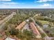 Aerial view of townhouses with tiled roofs, parking, and lush landscaping at 2648 Tanglewood Trl, Palm Harbor, FL 34685