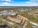 Aerial view of townhouses, roads, and surrounding landscape at 2648 Tanglewood Trl, Palm Harbor, FL 34685