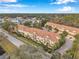 Aerial view of townhouses near a road and lush vegetation at 2648 Tanglewood Trl, Palm Harbor, FL 34685