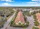 Aerial view of townhomes near a road and a body of water at 2648 Tanglewood Trl, Palm Harbor, FL 34685