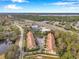 Aerial view showcasing townhouses near a roadway and body of water at 2648 Tanglewood Trl, Palm Harbor, FL 34685