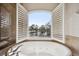 Bathroom with a view! Soaking tub with window overlooking pond at 2648 Tanglewood Trl, Palm Harbor, FL 34685