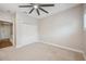 Bright bedroom with ceiling fan and double door closet at 2648 Tanglewood Trl, Palm Harbor, FL 34685