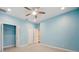 Bright bedroom with ceiling fan and double door closet at 2648 Tanglewood Trl, Palm Harbor, FL 34685