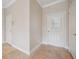 Neutral-toned entryway with tile flooring and white doors at 2648 Tanglewood Trl, Palm Harbor, FL 34685