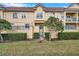 Townhouse exterior showcasing landscaping and a gated entryway at 2648 Tanglewood Trl, Palm Harbor, FL 34685