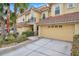 Tan townhome with a two-car garage and neatly landscaped yard at 2648 Tanglewood Trl, Palm Harbor, FL 34685