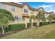 Townhouse exterior with manicured landscaping and gated entry at 2648 Tanglewood Trl, Palm Harbor, FL 34685