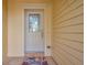 White front door with a glass panel and a welcome mat at 2648 Tanglewood Trl, Palm Harbor, FL 34685