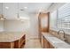 Spacious kitchen with granite countertops and wooden cabinetry at 2648 Tanglewood Trl, Palm Harbor, FL 34685