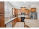 Spacious kitchen with granite countertops and wood cabinets at 2648 Tanglewood Trl, Palm Harbor, FL 34685