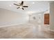 Spacious living room featuring tile floors and a ceiling fan at 2648 Tanglewood Trl, Palm Harbor, FL 34685