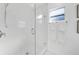 Modern shower with textured white walls and glass enclosure at 2735 Park N St, St Petersburg, FL 33710