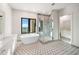 Spa-like bathroom with soaking tub, walk-in shower, and patterned tile at 2910 W Barcelona St # Ph-2302, Tampa, FL 33629