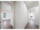 Long hallway with hardwood floors and doors to bedrooms at 2910 W Barcelona St # Ph-2303, Tampa, FL 33629