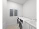 Bright laundry room, complete with washer, dryer, and utility sink at 2910 W Barcelona St # Ph-2303, Tampa, FL 33629