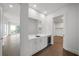 Modern wet bar with white cabinetry and wine cooler at 2910 W Barcelona St # Ph-2303, Tampa, FL 33629