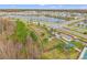 Aerial view of a community featuring a lake, homes, and a dog park at 3304 Suncoast Plains Dr, Odessa, FL 33556