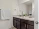 Double vanity bathroom with dark brown cabinets at 3304 Suncoast Plains Dr, Odessa, FL 33556