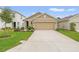 Two-story house with a two-car garage, and a green lawn at 3304 Suncoast Plains Dr, Odessa, FL 33556