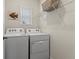 Laundry room with washer, dryer, and shelving at 3304 Suncoast Plains Dr, Odessa, FL 33556