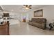 Living room with a brown couch and a view into the kitchen at 3304 Suncoast Plains Dr, Odessa, FL 33556