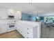 Open concept kitchen with white cabinets and island at 340 Pinellas Bayway S # 306, Tierra Verde, FL 33715