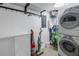 Bright laundry room, washer, dryer, and storage shelves at 340 Pinellas Bayway S # 306, St Petersburg, FL 33715