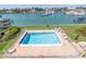 Community pool with patio furniture and water views at 340 Pinellas Bayway S # 306, Tierra Verde, FL 33715