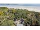 Aerial view of a house near the water with lush green trees at 356 Grand Central Ave, Safety Harbor, FL 34695