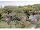 Aerial view of a home nestled among mature trees near the water at 356 Grand Central Ave, Safety Harbor, FL 34695