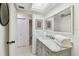 Bathroom featuring a marble vanity and a large mirror at 356 Grand Central Ave, Safety Harbor, FL 34695