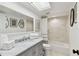 Clean bathroom with a bathtub, marble vanity, and skylight at 356 Grand Central Ave, Safety Harbor, FL 34695