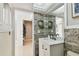 Modern bathroom with white vanity and stone feature wall at 356 Grand Central Ave, Safety Harbor, FL 34695