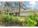 Ranch style home with a newly paved driveway and lush landscaping at 356 Grand Central Ave, Safety Harbor, FL 34695