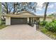 Home exterior with a gray garage door and brick paver driveway at 356 Grand Central Ave, Safety Harbor, FL 34695