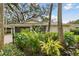 House exterior with a lush, manicured front yard and a gray garage door at 356 Grand Central Ave, Safety Harbor, FL 34695