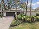 Single story home with a dark gray garage door and brick driveway at 356 Grand Central Ave, Safety Harbor, FL 34695