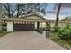 House exterior featuring a dark brown garage door and brick driveway at 356 Grand Central Ave, Safety Harbor, FL 34695