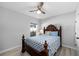 Cozy bedroom with a wooden bed frame, light blue bedding, and a ceiling fan at 37137 Florida Ave, Dade City, FL 33525